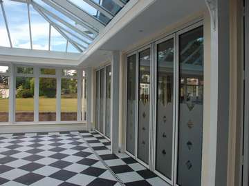 North Wales Mold - Installation of S1000 White Aluminium Bi fold doors double glazed in a K2 Portal Conservatory - Glass Celsius one clear North Wales PvcU Bi fold doors with aluminium Windows North Wales 